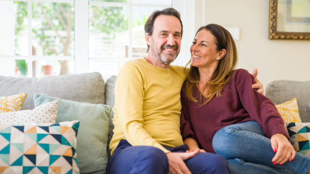 happy couple sitting on couch together