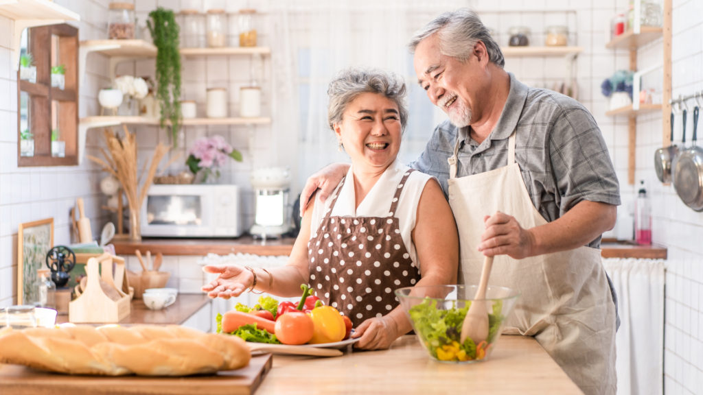 smiling couple making cooking together