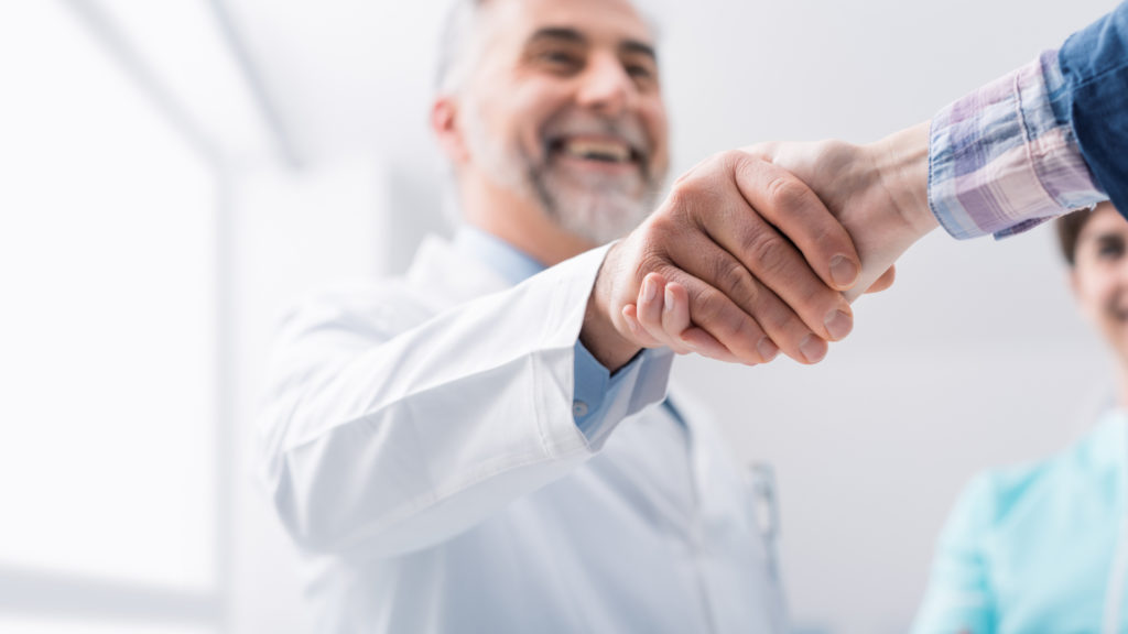 doctor shaking hands with patient