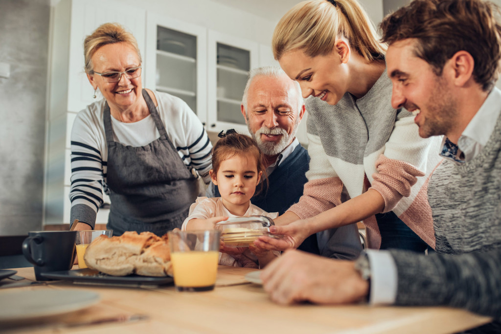three generations of family members cooking together
