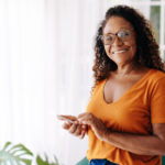 smiling adult woman using smartphone
