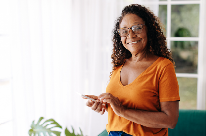 smiling adult woman using smartphone